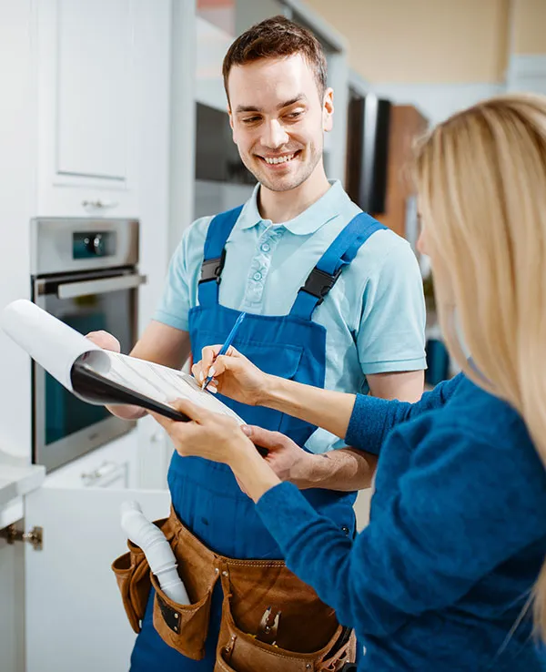 male-plumber-and-female-customer-in-the-kitchen